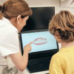Dentist showing teeth scan to boy
