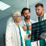 Group of radiology doctor looking at x-ray and discussing it